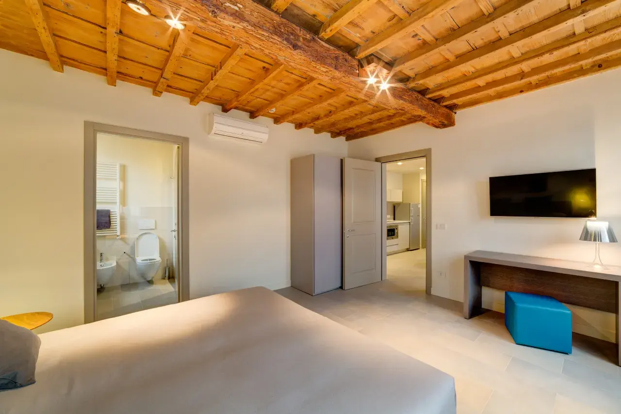 View of the master bedroom with the bathroom and kitchen in the background - Bilo Deluxe.
