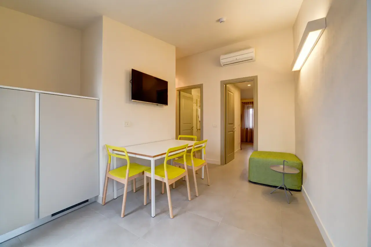 Living room with dining table and chairs in a Bilo View apartment.