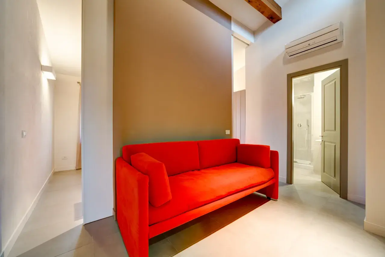 Elegant red sofa in the living room of a Bilo View apartment.