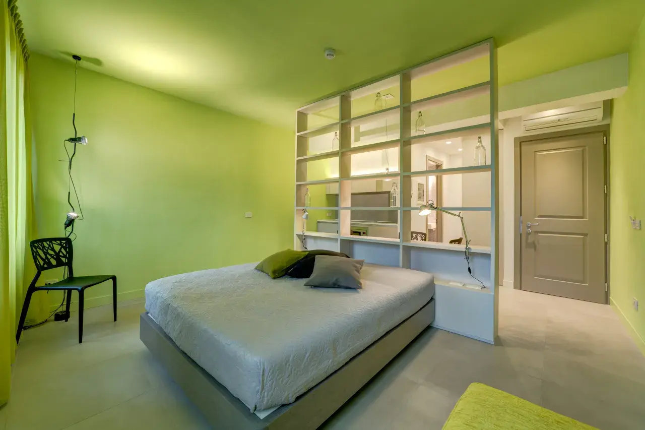 Close-up of the double bed in a Mono Smart apartment at Palazzo Mannaioni.