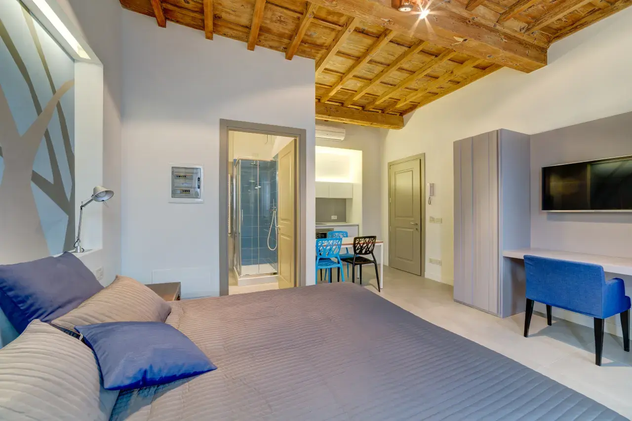 Overview of a Mono Smart apartment with a double bed in the foreground.